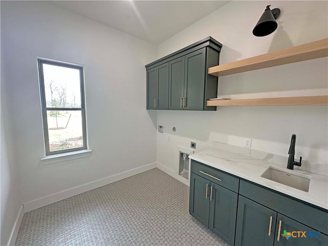 laundry area featuring hookup for a washing machine, cabinet space, a sink, electric dryer hookup, and baseboards