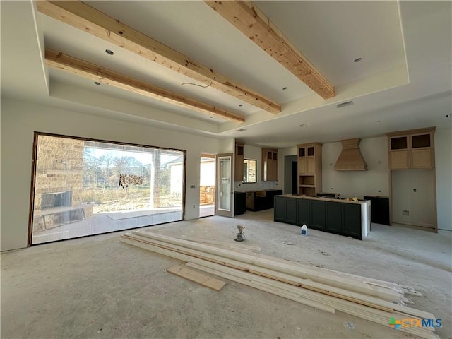 unfurnished living room featuring beamed ceiling