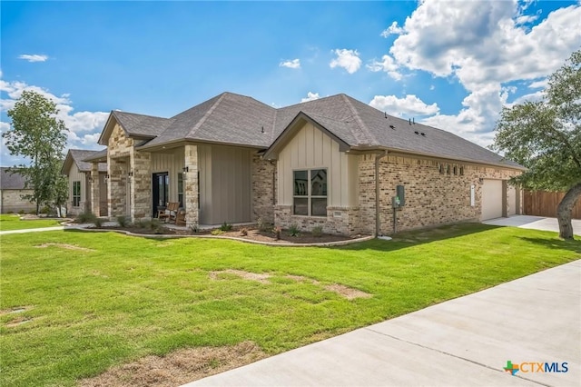 1586 Bosque Lago Dr, Belton, TX 76513 - view of front facade with board and batten siding, concrete driveway, a front lawn, and a garage