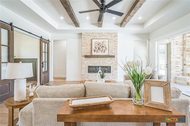 1586 Bosque Lago Dr, Belton, TX 76513 - living room with a barn door, beamed ceiling, a ceiling fan, recessed lighting, and baseboards