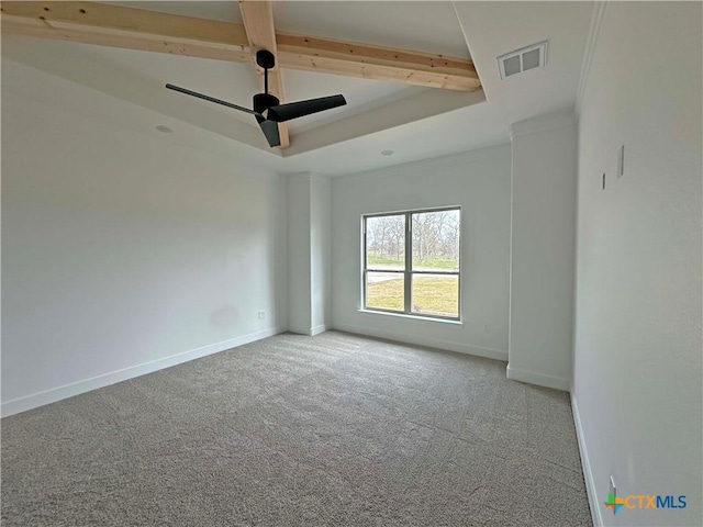 carpeted empty room featuring baseboards, visible vents, a raised ceiling, and a ceiling fan