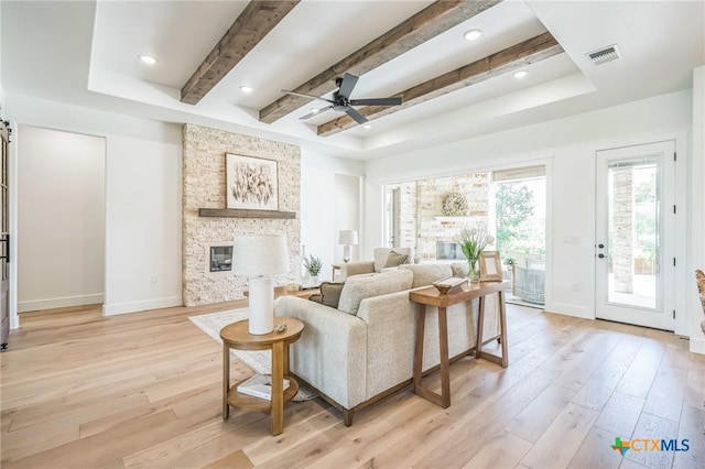 1586 Bosque Lago Dr, Belton, TX 76513 - living room featuring light wood-type flooring, a ceiling fan, a tray ceiling, baseboards, and beam ceiling
