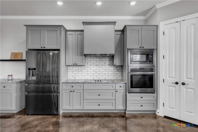 kitchen with light stone countertops, stainless steel appliances, and ornamental molding