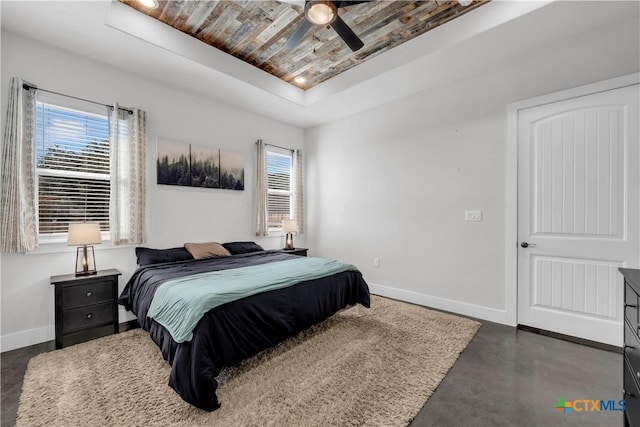 bedroom featuring ceiling fan and a tray ceiling