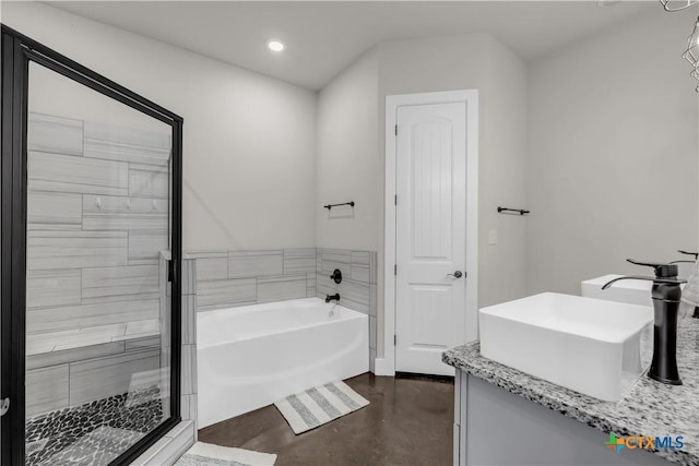 bathroom featuring plus walk in shower, vanity, and concrete floors