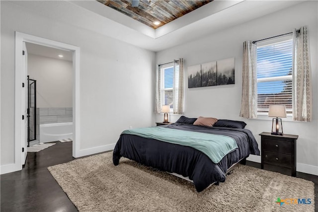 bedroom featuring a tray ceiling and wooden ceiling