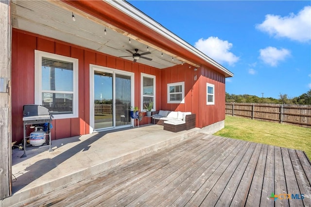 wooden deck featuring outdoor lounge area, a yard, grilling area, and ceiling fan