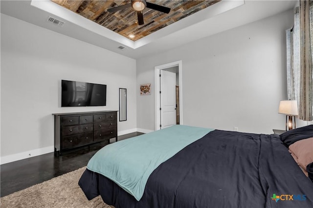 bedroom featuring a tray ceiling, ceiling fan, and wood ceiling