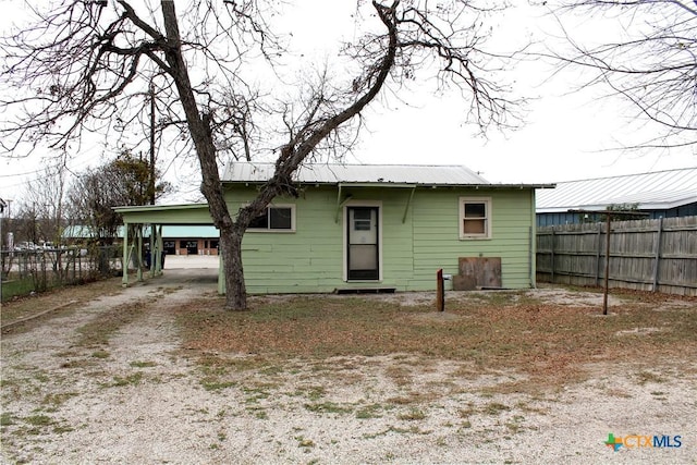 rear view of house featuring a carport