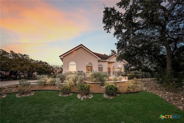 view of front of home with a lawn