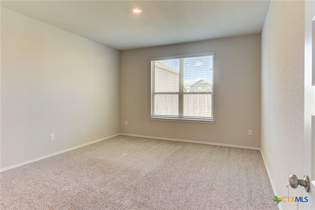 unfurnished room featuring carpet flooring