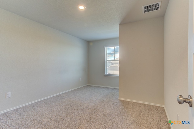 unfurnished room with light colored carpet