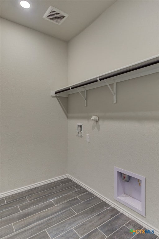 clothes washing area with dark hardwood / wood-style flooring, gas dryer hookup, and hookup for a washing machine