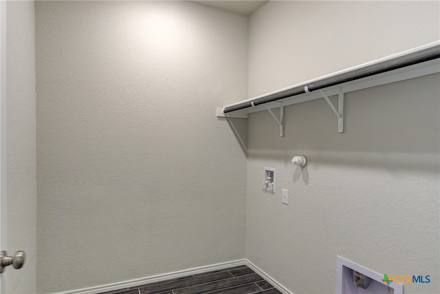 laundry area featuring dark hardwood / wood-style flooring, hookup for a washing machine, and gas dryer hookup