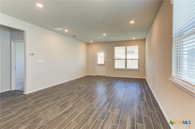 unfurnished room with dark wood-type flooring