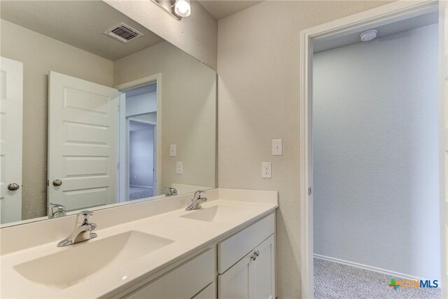 2420 Dielman Dr, Seguin, TX 78155 - bathroom featuring baseboards and double vanity