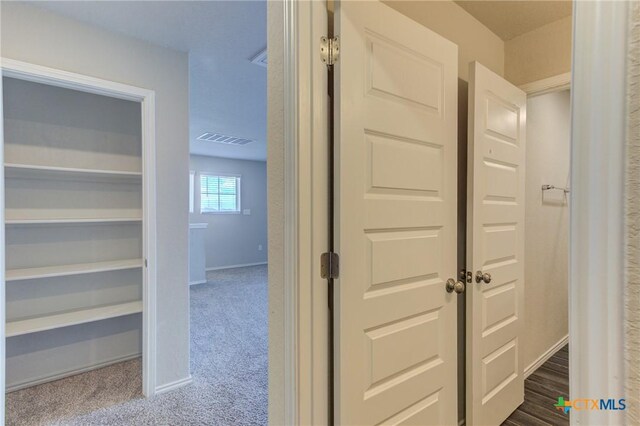 2420 Dielman Dr, Seguin, TX 78155 - hallway with dark carpet and baseboards