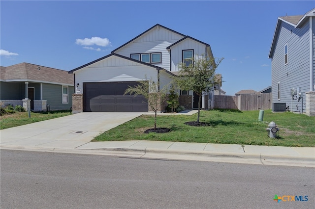 view of front facade with central AC unit, a garage, and a front yard