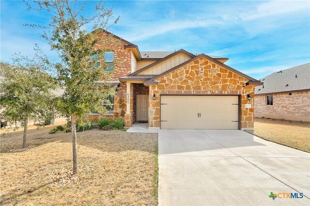 craftsman inspired home with stone siding, an attached garage, board and batten siding, and driveway