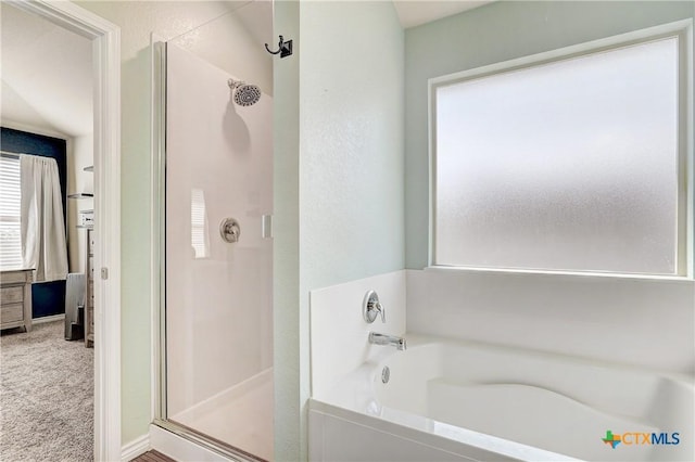 full bathroom with a shower stall and a garden tub