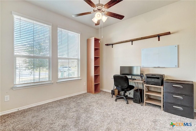 office space with baseboards, carpet floors, and ceiling fan