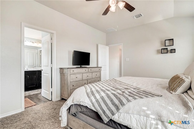 carpeted bedroom with visible vents, baseboards, ceiling fan, and ensuite bathroom