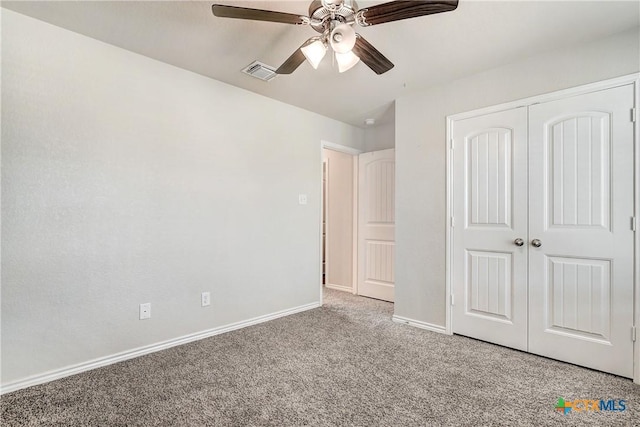 unfurnished bedroom with a ceiling fan, baseboards, visible vents, carpet floors, and a closet