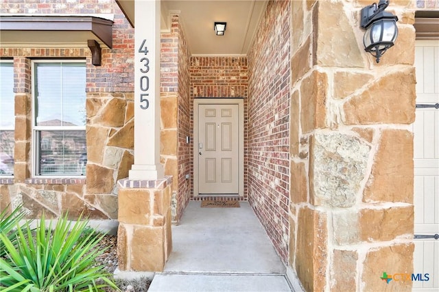 property entrance with brick siding