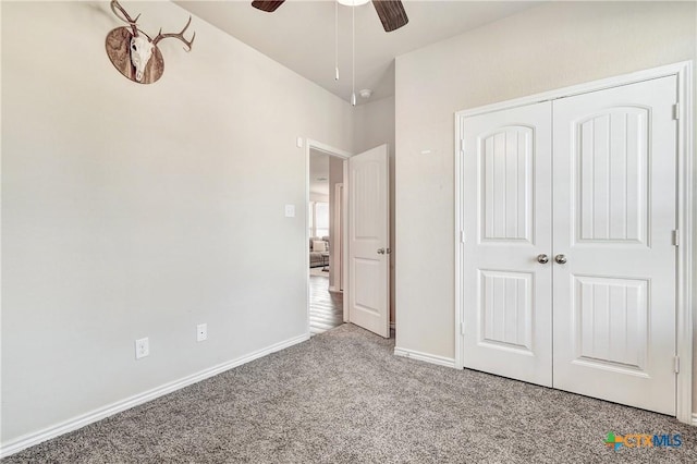 unfurnished bedroom featuring a closet, ceiling fan, baseboards, and carpet floors