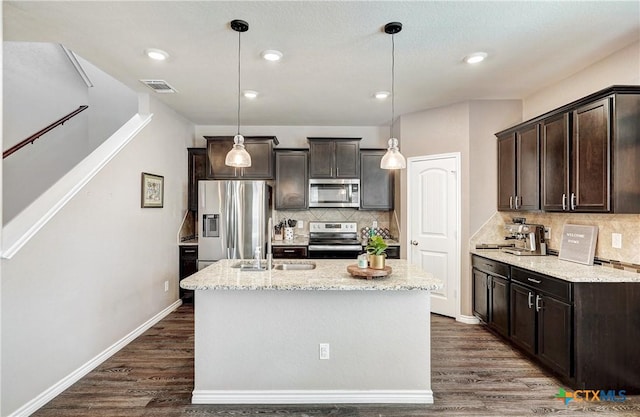 kitchen featuring visible vents, dark wood-style flooring, a sink, stainless steel appliances, and dark brown cabinets