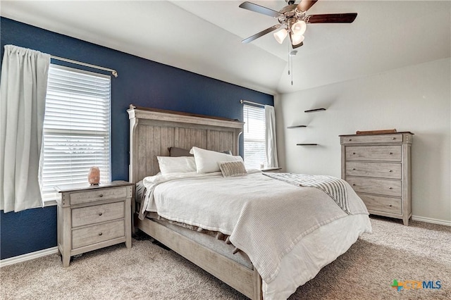 bedroom with light colored carpet, a ceiling fan, baseboards, and vaulted ceiling