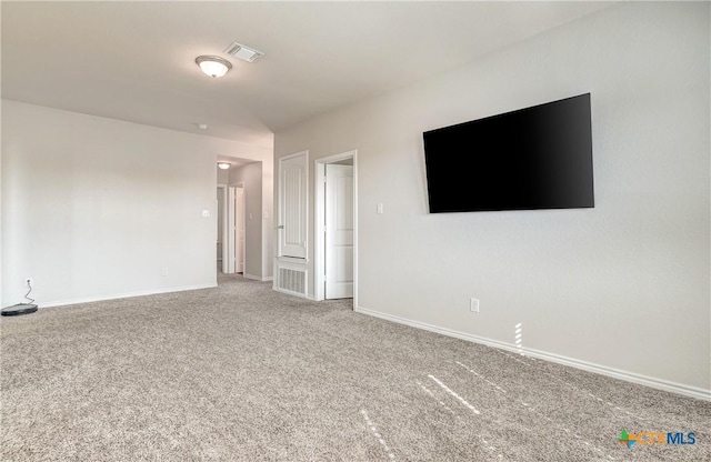 carpeted empty room featuring visible vents and baseboards