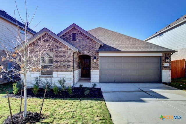 view of front facade featuring a garage and a front lawn