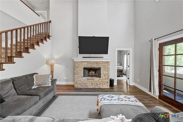 4130 Cripple Creek Dr, Temple, TX 76502 - living area with stairway, a high ceiling, wood finished floors, baseboards, and a fireplace