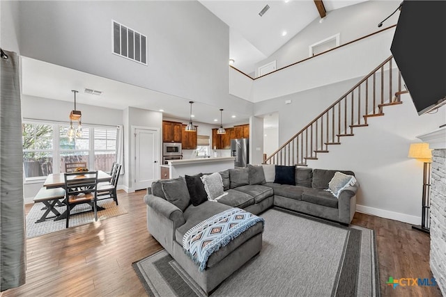 4130 Cripple Creek Dr, Temple, TX 76502 - living room featuring wood finished floors, visible vents, and stairway