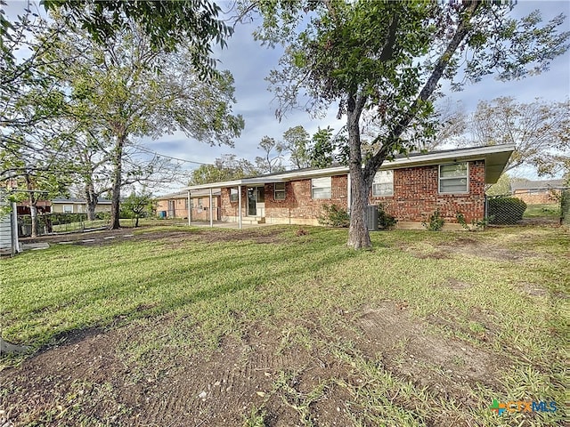 ranch-style house featuring central air condition unit and a front yard