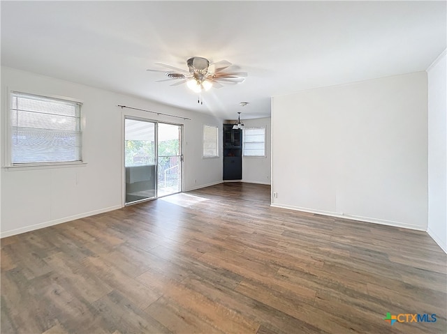 empty room featuring ceiling fan and dark wood-type flooring