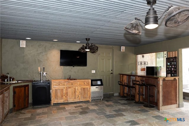 211 Cambridge Dr, New Braunfels, TX 78132 - bar featuring stone tile floors, recessed lighting, indoor bar, and a sink