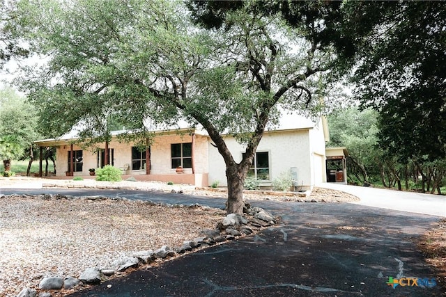 211 Cambridge Dr, New Braunfels, TX 78132 - view of front facade with aphalt driveway and stucco siding