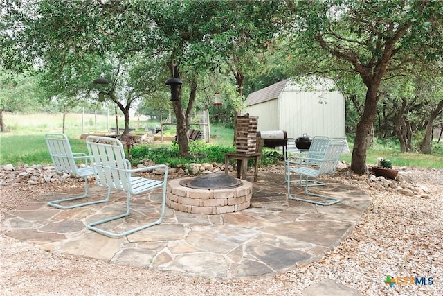 211 Cambridge Dr, New Braunfels, TX 78132 - view of patio with a fire pit and an outbuilding