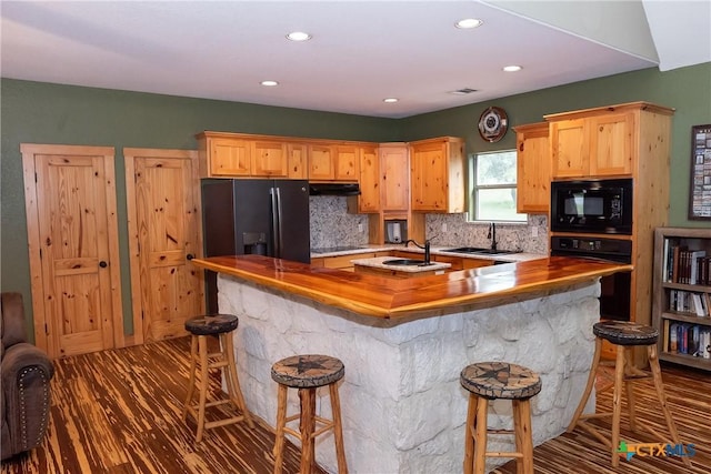 211 Cambridge Dr, New Braunfels, TX 78132 - kitchen featuring black appliances, backsplash, light brown cabinets, and a sink
