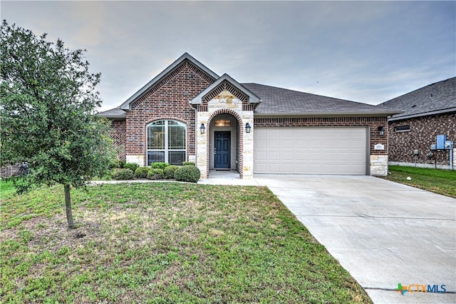 830 Wyndcrest Dr, Temple, TX 76502 - french country inspired facade with brick siding, driveway, an attached garage, and a front lawn