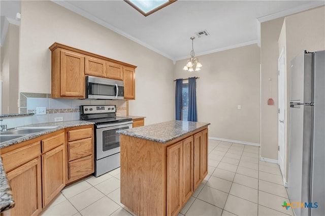 kitchen featuring light tile patterned floors, ornamental molding, a kitchen island, stainless steel appliances, and light stone countertops