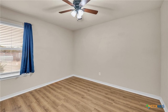 empty room with ceiling fan and light hardwood / wood-style flooring