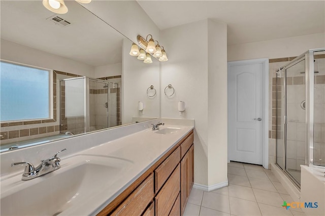 bathroom with walk in shower, tile patterned floors, and vanity