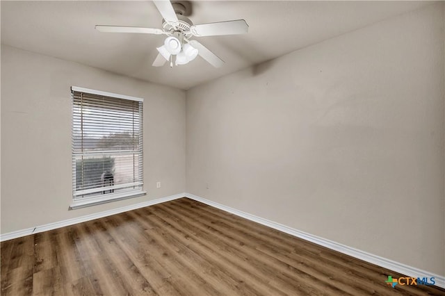 spare room featuring dark hardwood / wood-style flooring and ceiling fan