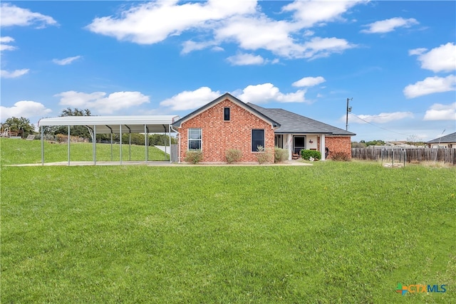 exterior space featuring a carport and a yard