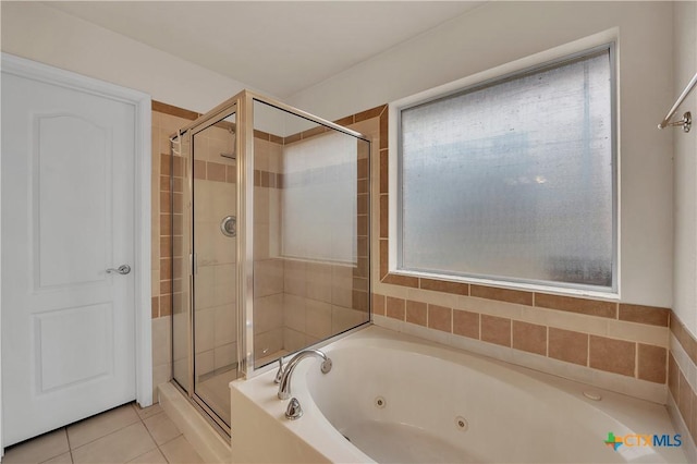 bathroom featuring independent shower and bath and tile patterned flooring