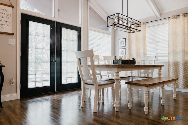 dining space featuring french doors, baseboards, a chandelier, wood finished floors, and beam ceiling
