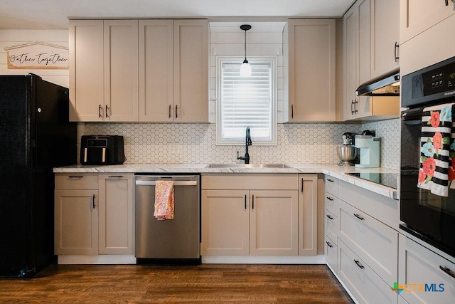 kitchen featuring under cabinet range hood, a sink, backsplash, black appliances, and light countertops